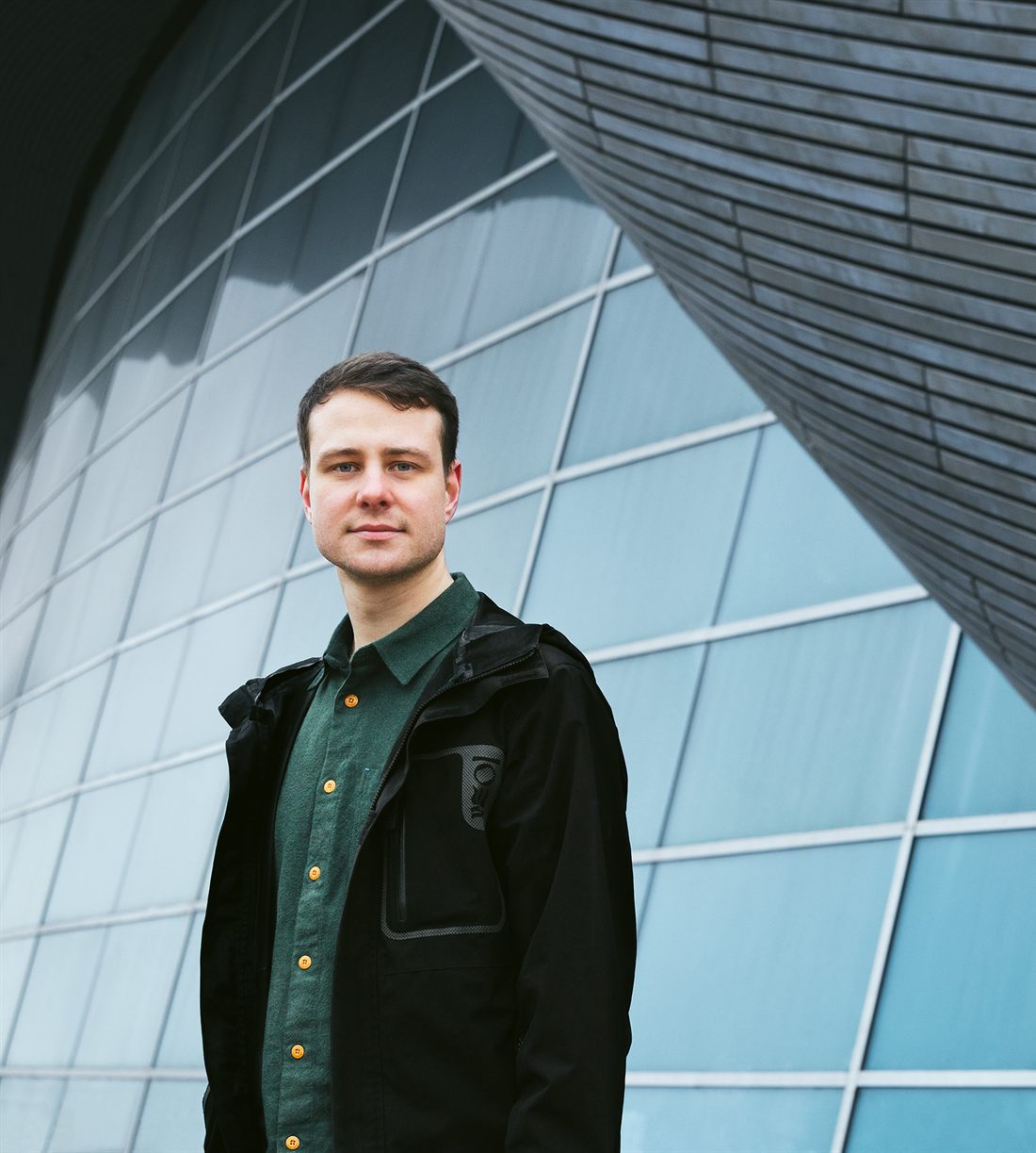 Phil Fieldhouse, photographed against a glass building.